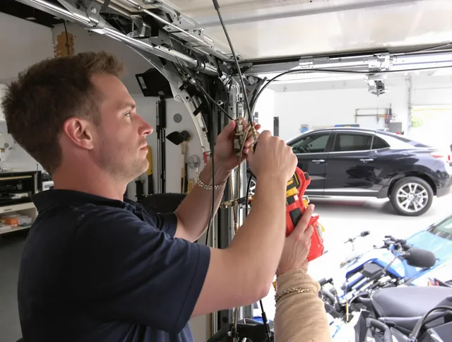 Reynoldsburg Garage Door Repair safety certified technician performing cable replacement in Reynoldsburg